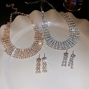 Luxurious rhinestone necklace and earring set in gold and silver finish on ceramic tray