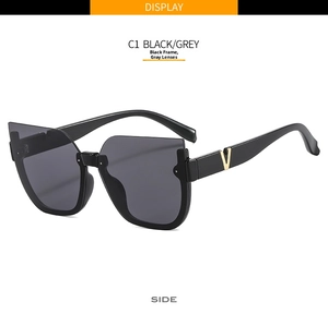 Detail shot of black cat-eye sunglasses with luxury gold V metal logo on the temple