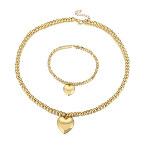 Golden stainless steel bead jewelry set with heart pendants on a clean white background