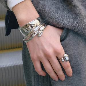 Detail of silver stainless steel cuff bracelet with marquise zircon on a female wrist