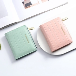 Slim women's bifold wallet with crocodile pattern in mint green and pink colors