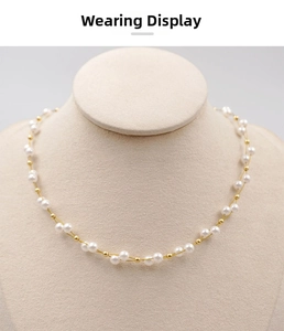 Close-up of handmade double-strand pearl necklace with gold beads on a neck mannequin