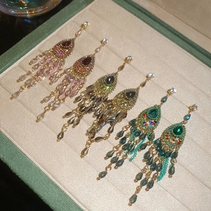 Three pairs of bohemian crystal water drop tassel earrings in a green velvet jewelry box