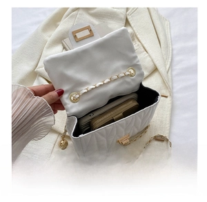 Interior view showing the large capacity of the quilted crossbody bag for daily essentials