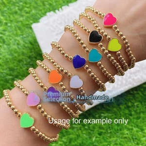 Set of 10 golden beaded elastic bracelets with colorful heart-shaped enamel charms