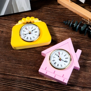 Creative birdhouse and handbag style desk clocks with Roman numerals on wood background