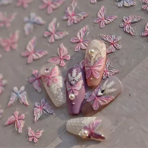 Detail of 3D embossed butterfly nail stickers with lace patterns and pearl accents