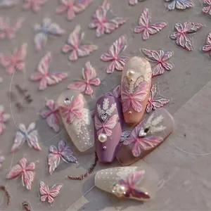 Detail of 3D embossed butterfly nail stickers with lace patterns and pearl accents
