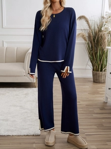 Deep blue knit loungewear set with white trim details on the long sleeve top and wide pants