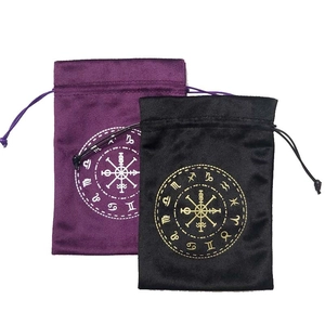 Detail showing purple and black velvet tarot bags with gold zodiac constellations