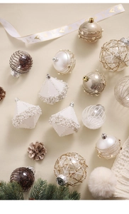 Detailed assortment of champagne and white Christmas ornaments with glitter and beads
