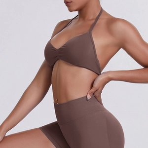 Detail of dark cocoa brown halter sports bra and high-waisted seamless biker shorts set