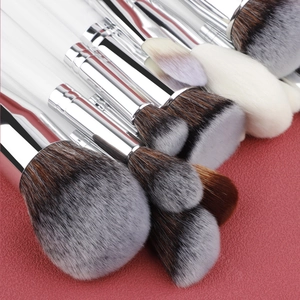 Detail of 30-piece professional makeup brush set with soft synthetic hair and white handles