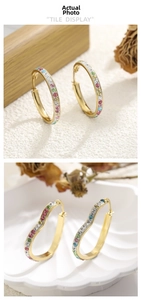 Detail of gold-plated hoop earrings with multicolored rhinestones in heart and circle shapes
