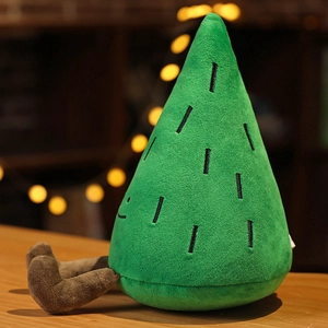 Plush pine tree toy with smiling face and dangling legs on wooden surface