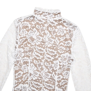 Detail of the white lace long sleeve dress back featuring intricate floral patterns