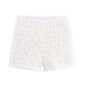 Detail of white crochet hollow-out lace shorts with elastic waistband and floral patterns