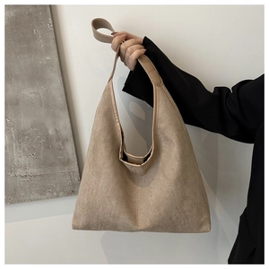 Detailed texture of khaki suede tote bag featuring a premium leather shoulder strap