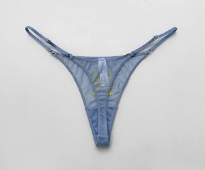 Detail view of light blue mesh thong featuring intricate yellow butterfly embroidery