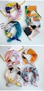Detail of assorted silk square scarves with vibrant digital prints and knotted styling