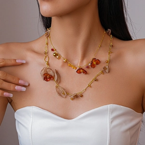 Close-up of retro layered necklace with amber acrylic flowers and chiffon fabric petals