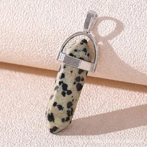 Macro detail of hexagonal Dalmatian Jasper pendant with polished silver alloy clasp