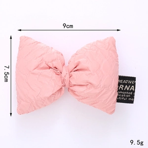 Pink quilted fabric bow DIY accessory with 9cm width and black label for hats and bags
