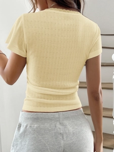 Back view of a light yellow Y2K knit top with lace trim and button detail