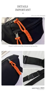 Detail of durable black nylon chest bag with orange braided zipper pull and buckle