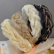 Detail of woven mesh headbands with glittering rhinestones in four elegant colors