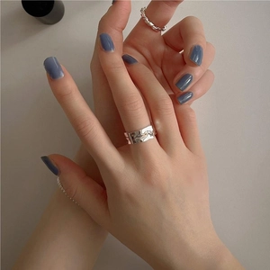 Minimalist S925 sterling silver wide band ring with irregular textured surface on hand