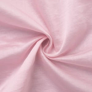 Macro detail of glossy pink lantern sleeve fabric with pleated texture and silk-like finish