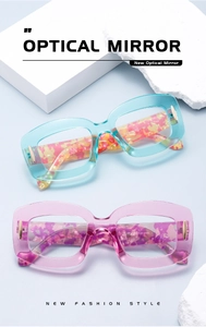 Detailed view of blue and pink thick-framed anti-blue light glasses with marble temples