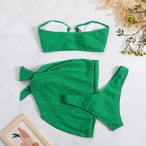 Detail of green three-piece bikini set with sequined hollow fabric and matching sarong