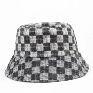 Close-up of thick wool checkerboard bucket hat showing black and grey knit texture