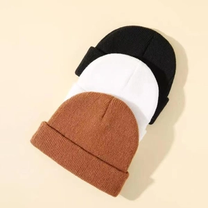 Three-pack ribbed knit beanies in black, white, and caramel colors for winter warmth