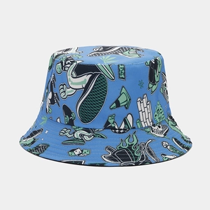 Close-up of blue reversible bucket hat with graffiti prints including skate shoes and skulls