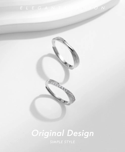 Detail shot of Mobius silver rings showing the twisted design and delicate diamond setting