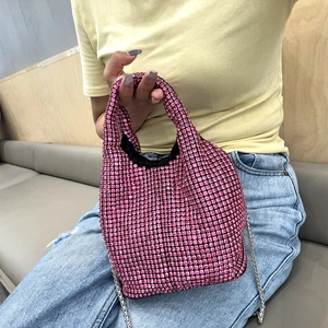 Detailed close-up of pink rhinestone bucket bag with silver chain and metal handle