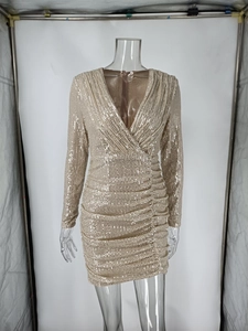 Detail of champagne gold sequin mini dress with V-neck and ruched wrap style