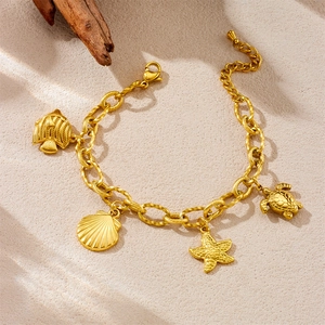 Gold ocean themed stainless steel bracelet with starfish turtle and seashell charms