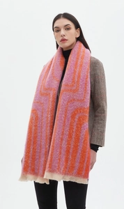 Detail of pink and orange geometric jacquard scarf with short fringe on model