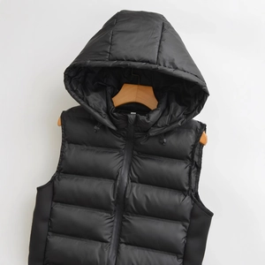 Women's black hooded puffer vest with quilted texture and zipper closure on white background