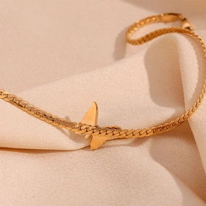 Detail of 18K gold-plated stainless steel NK chain with turquoise butterfly pendant