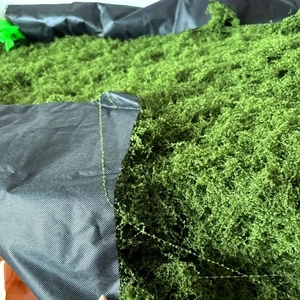 Detailed macro texture of vibrant green artificial moss turf for landscape landscaping