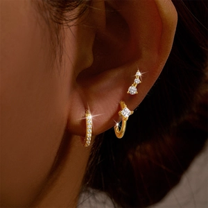 Close-up of gold plated ear set with micro-pave and emerald cut cubic zirconia
