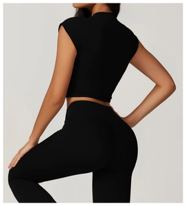 Rear view of tight black fitness set with high-waist yoga pants and crop top for women
