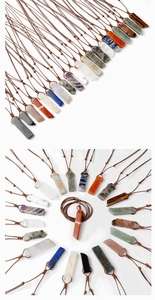 Detail showing various rectangular natural stone pendants with brown braided cord necklaces