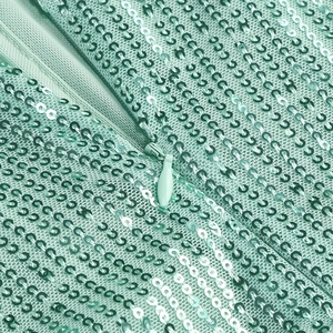 Close-up of invisible zipper and sequin embroidery on mint green sequined evening dress