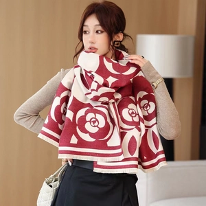 Close-up of red and white floral jacquard scarf featuring elegant tassels and thick texture